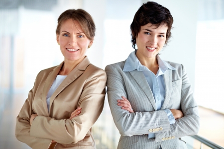 Portrait of two strong women in business standing shoulder to shoulder expressing unityの写真素材
