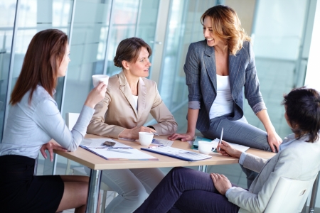 Pretty females discussing business matters in the boardroomの写真素材