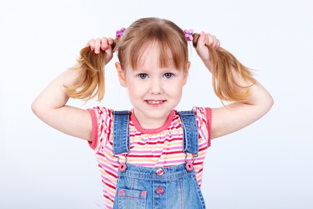 Portrait of a sweet girl in a denim jumpsuitの写真素材