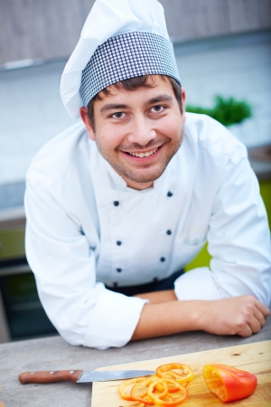 Portrait of happy man in cook uniform looking at cameraの写真素材