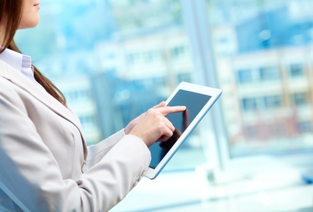 Close-up of businesswoman working with touchpad in office