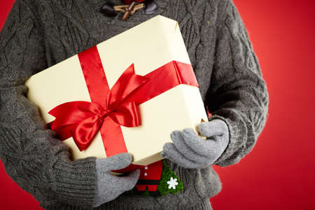 Image of giftbox in gloved male hands
