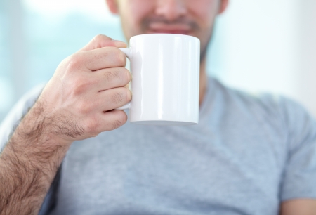 Close-up of male hand holding mugの写真素材