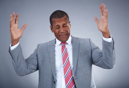 Photo of businessman expressing confusion on grey background