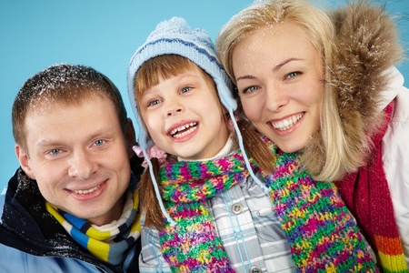 Happy parents and their daughter looking at camera with smilesの写真素材