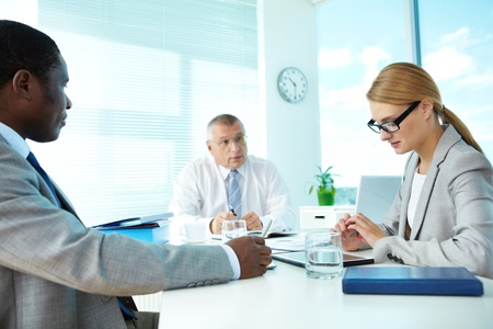 Portrait of smart employees and their boss on background at meetingの写真素材