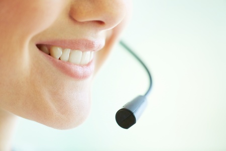 Smiling telemarketing operator giving a consultation concerning the productの写真素材