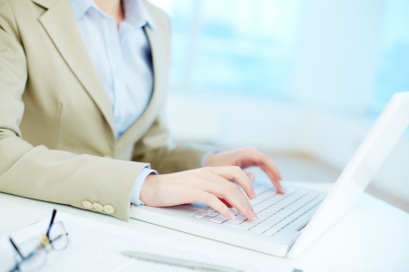 Close-up of white collar worker typing on laptopの写真素材