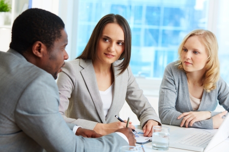 Group of friendly businesspeople interacting at meetingの写真素材
