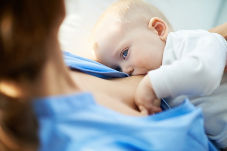 Close-up of woman breastfeeding her small sonの写真素材