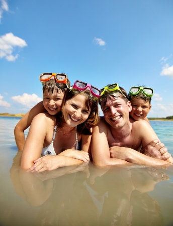 Photo of happy family looking at camera on resortの写真素材