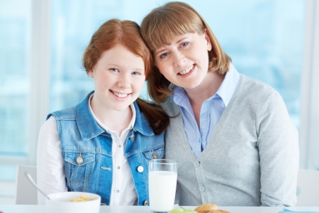 Lovely girl and her mother looking at camera with smilesの写真素材