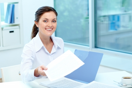 Portrait of happy employer giving test results to applicantの写真素材