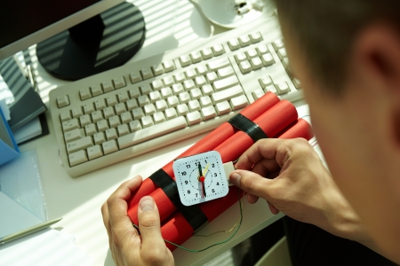 Close-up of businessman preparing bomb in office 