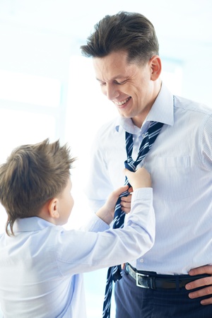 Photo of happy boy helping his father tie necktieの写真素材