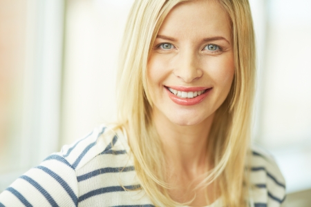 Portrait of pretty woman looking at camera with smileの写真素材