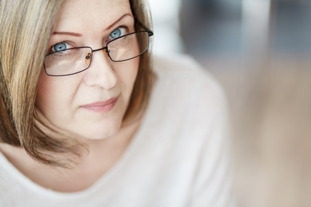 Mature woman in eyeglasses looking at cameraの写真素材