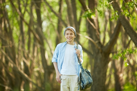 Portrait of cute lad in casual clothes outside   の写真素材