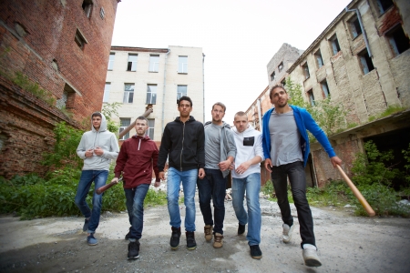Portrait of spiteful hooligans walking down street Portrait of spiteful hooligans walking down street