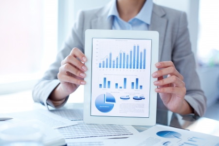 Close-up of businesswoman presenting financial solution in touchpadの写真素材