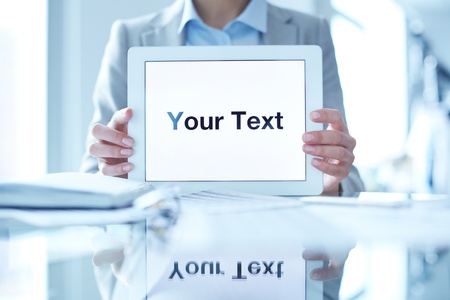 Close-up of businesswoman holding touchpad with your text on displayの写真素材