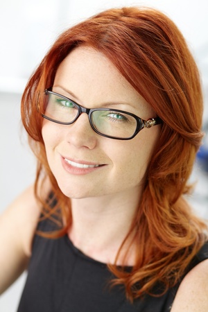 Close-up shot of a wonderful red-haired woman with a pleasant smile