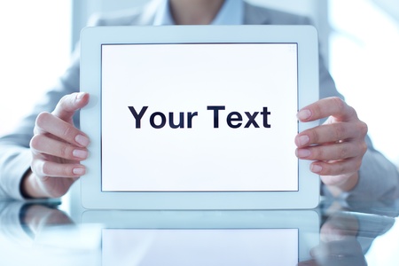 Close-up of businesswoman holding touchpad with your text on displayの写真素材
