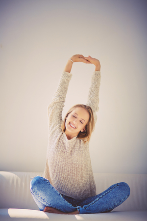 Young girl with closed eyes enjoying wonderful morningの写真素材