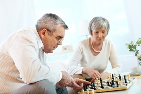 Portrait of senior couple playing chess at leisure の写真素材