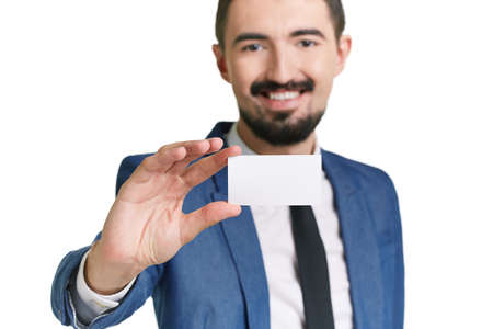 Close-up of blank card shown by succesful young businessmanの写真素材