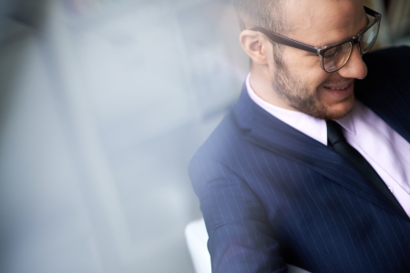 Businessman in eyeglasses working in officeの写真素材