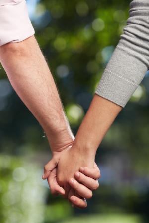 Conceptual image of female and male hands together の写真素材