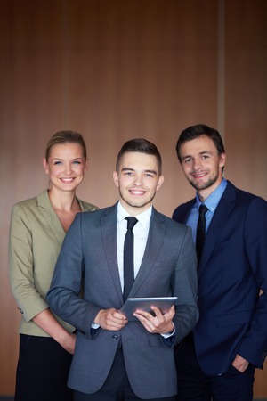 Group of business partners looking at camera with smilesの写真素材