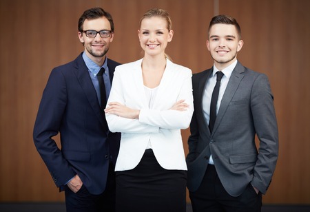Group of business partners looking at camera with smiles