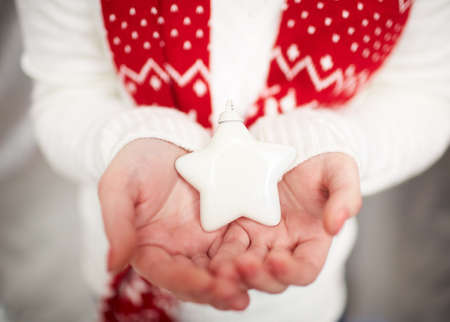 Image of decorative toy star on female handsの写真素材
