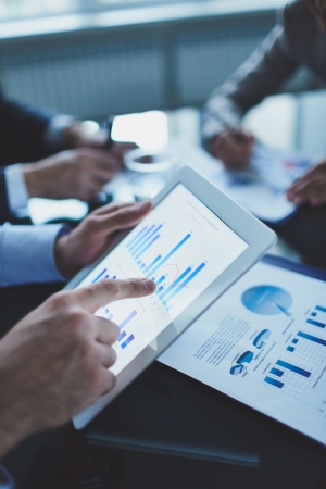 Image of businessperson pointing at document in touchpad at meetingの写真素材