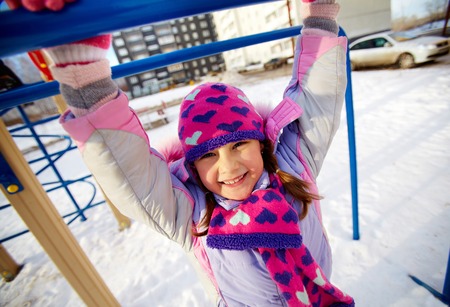 Happy girl in winterwear having fun outside