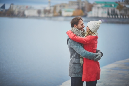 Portrait of happy guy and his girlfriend in embraceの写真素材