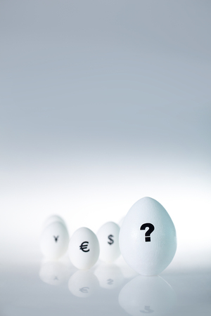 Close-up of white eggs with different signs on shellの写真素材