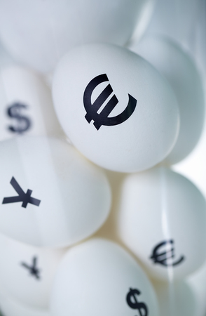 Image of eggs with currency signs in glassの写真素材