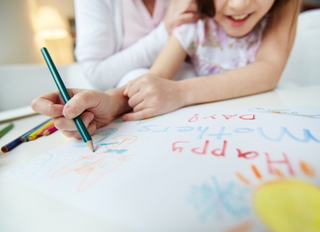 Little girl making greeting card for her mom on mothers dayの写真素材