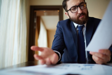 Elegant businessman working with document in officeの写真素材