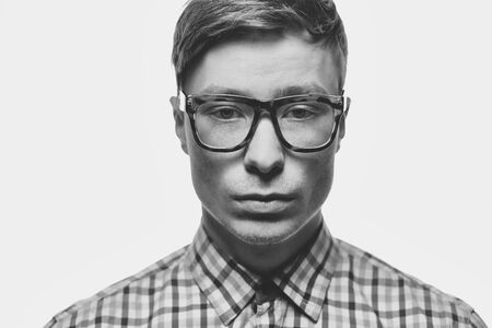 Face of young guy in eyeglasses looking at cameraの写真素材