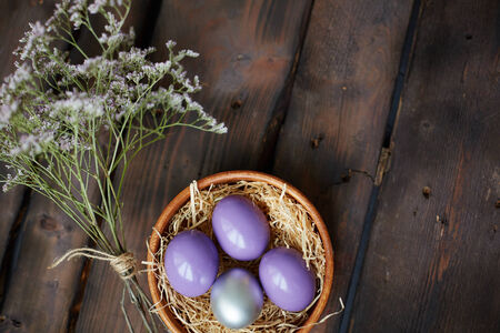 Colorful Easter eggs and dry flowers near by