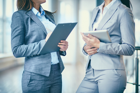 Close-up of two businesswomen interacting at meetingの写真素材