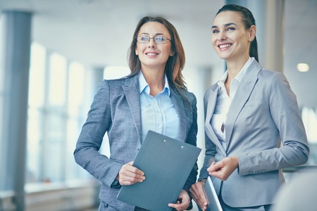 Image of two confident businesswomen in formalwear looking forwardsの写真素材