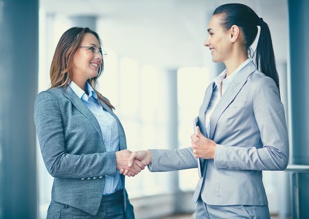 Image of two confident businesswomen handshakingの写真素材