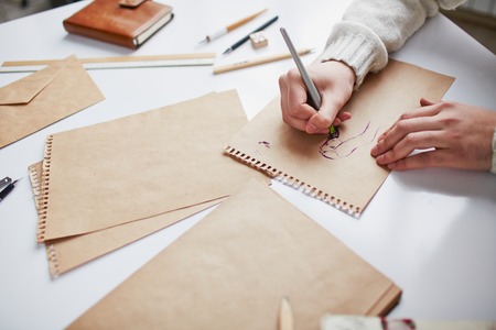 Image of male hands drawing pictures