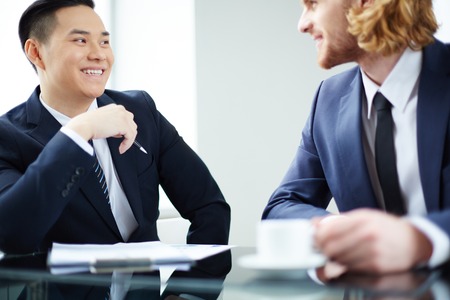 Two successful entrepreneurs interacting at meetingの写真素材