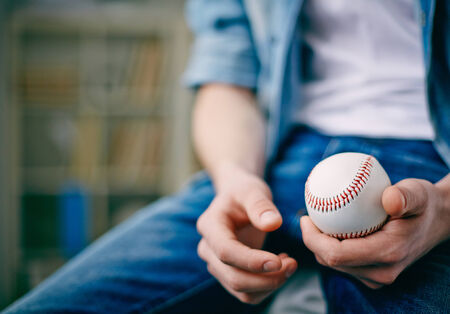 Hands of guy holding tennis ballの写真素材